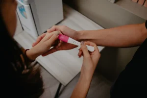 Close-up of a couple holding hands around a negative pregnancy test, highlighting mutual support while facing fertility challenges.