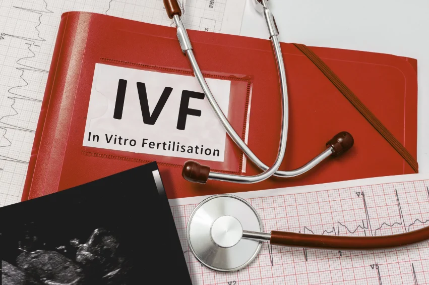 Stethoscope resting on a red folder labeled IVF outlining how long does ivf take in singapore.