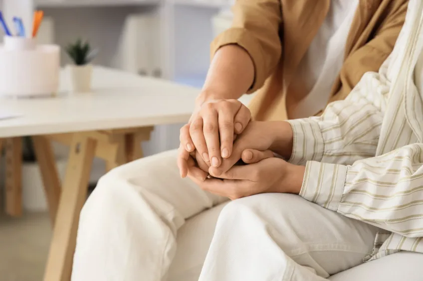 Couple holding hands offer support while discussing IVF success rate Singapore options.